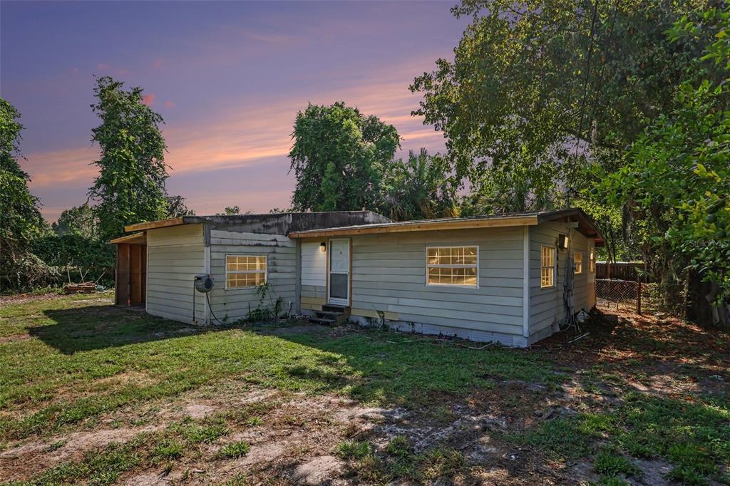 A single-story house with light-colored siding and a flat roof sits on a grassy lot — 4030 N LASSO TERRACE, HERNANDO, FL
