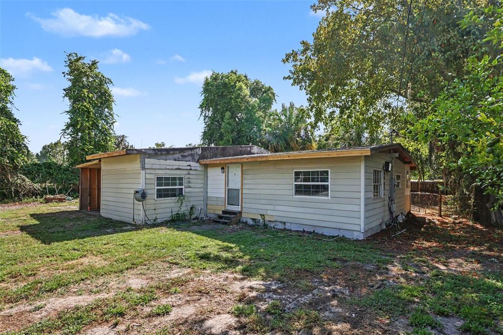 A single-story house with light-colored siding and a flat roof sits on a grassy lot — 4030 N LASSO TERRACE, HERNANDO, FL