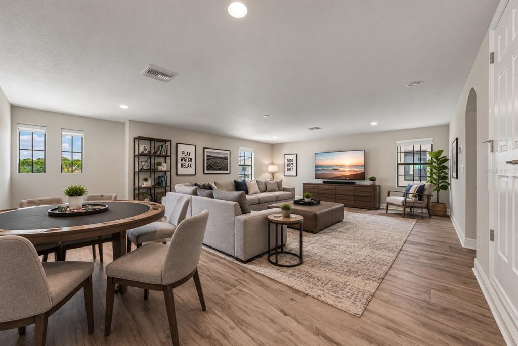 A spacious game room features wood-look flooring, a ping pong table, and a sectional sofa — 14633 RED CASTLE AVENUE, LITHIA, FL