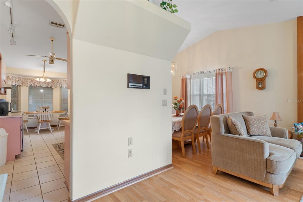 A view from a living area looking into a dining room and kitchen — 2501 MARINER BOULEVARD, SPRING HILL, FL