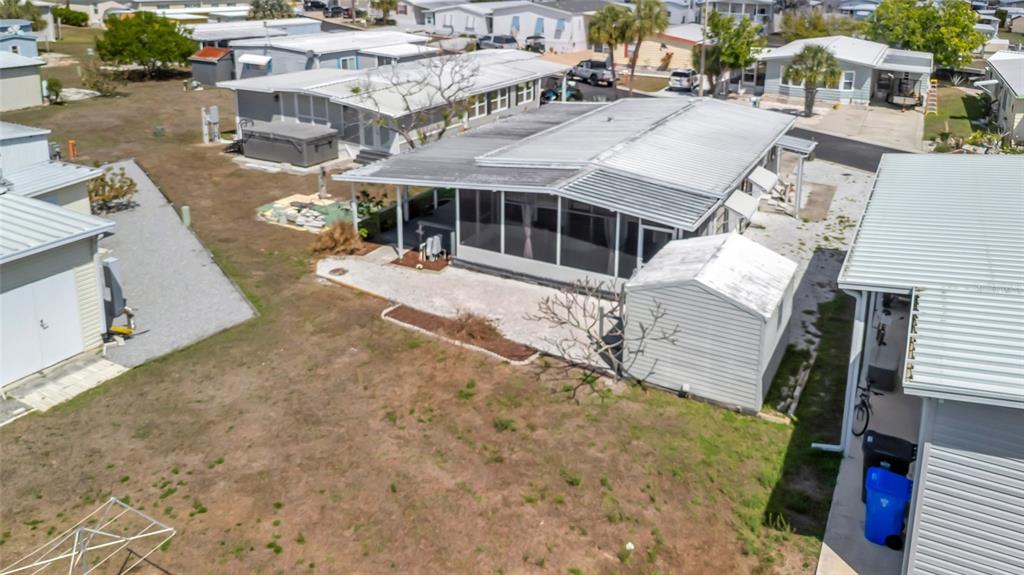 An aerial view shows a mobile home with a screened porch and a detached shed — 110 E SAINT LUCIA LOOP, APOLLO BEACH, FL