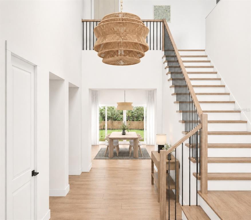 This rendering shows an entryway with a staircase, herringbone wood floors, and a large chandelier — 3520 W PRICE AVENUE, TAMPA, FL