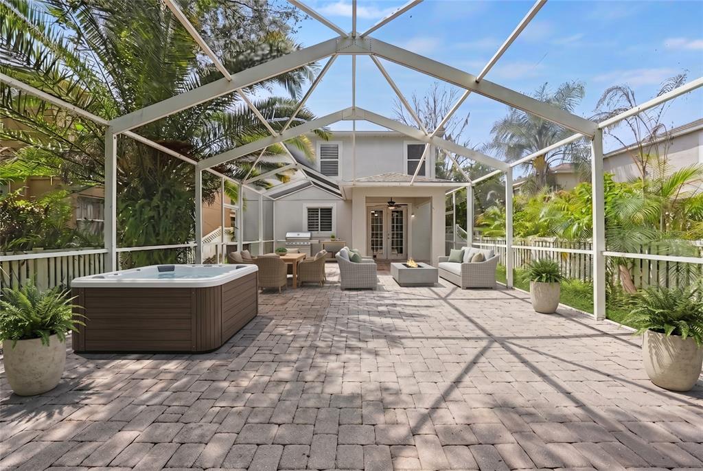 A two-story house with a white garage door, beige siding, and a concrete driveway — 2436 SPRING HOLLOW LOOP, WESLEY CHAPEL, FL
