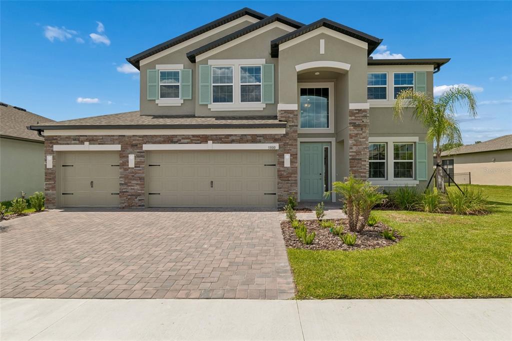 This is a floor plan of a single-story home featuring a three-car garage and lanai — 5800 FREESIA DRIVE, LAKELAND, FL