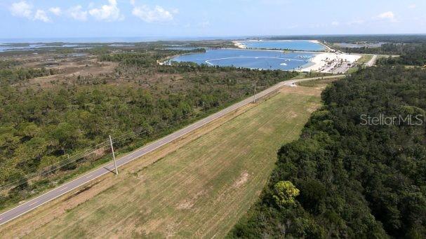 An aerial view shows a road running through a grassy field near a coastal lagoon — 00 OLD DIXIE HIGHWAY, HUDSON, FL