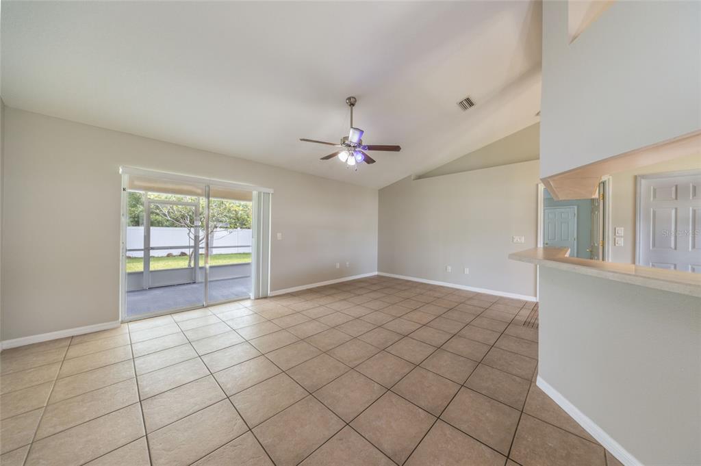 A kitchen with white cabinets, stainless steel appliances, and light-colored tile flooring — 37 ROCKEFELLER DRIVE, PALM COAST, FL