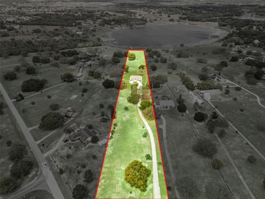 An aerial view shows a long, narrow residential lot with a house and driveway — 11155 CHERRY LAKE ROAD, CLERMONT, FL