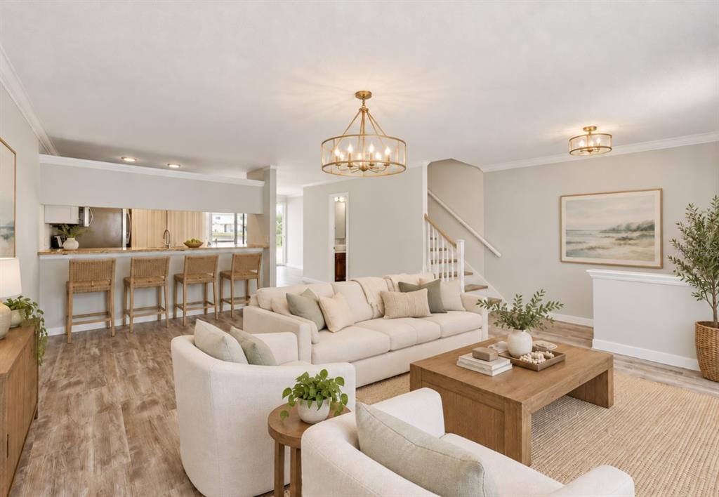 A kitchen features dark wood cabinets, stainless steel appliances, granite countertops, and light wood flooring — 5314 ABINGER COURT, TAMPA, FL