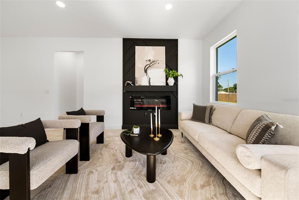 An empty bedroom features white walls, wood-look flooring, a ceiling fan, and a single window — 2831 W LIVINGSTON STREET, ORLANDO, FL