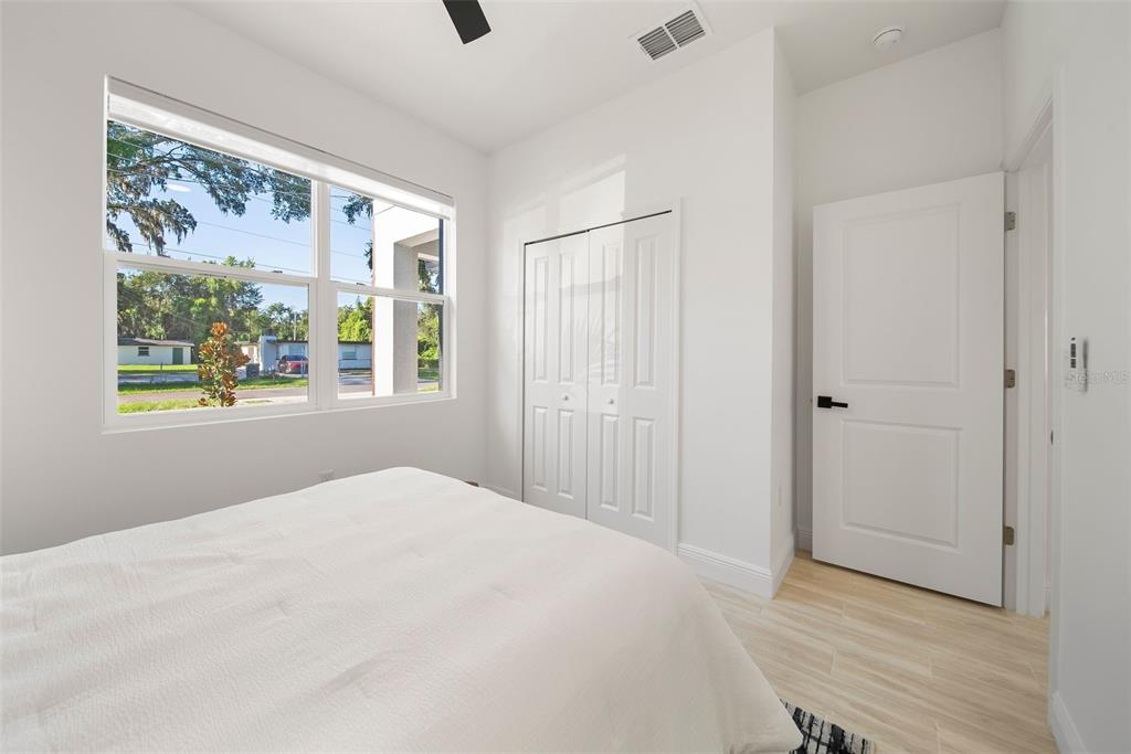 A kitchen features a granite-topped island, dark cabinetry, stainless steel appliances, and light flooring — 2831 W LIVINGSTON STREET, ORLANDO, FL