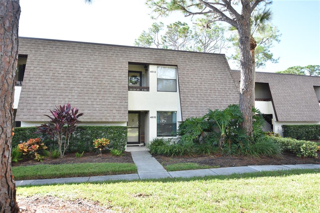 A two-story residential building with a shingled roof and landscaped front yard — 4610 RINGWOOD MEADOW UNIT 17, SARASOTA, FL