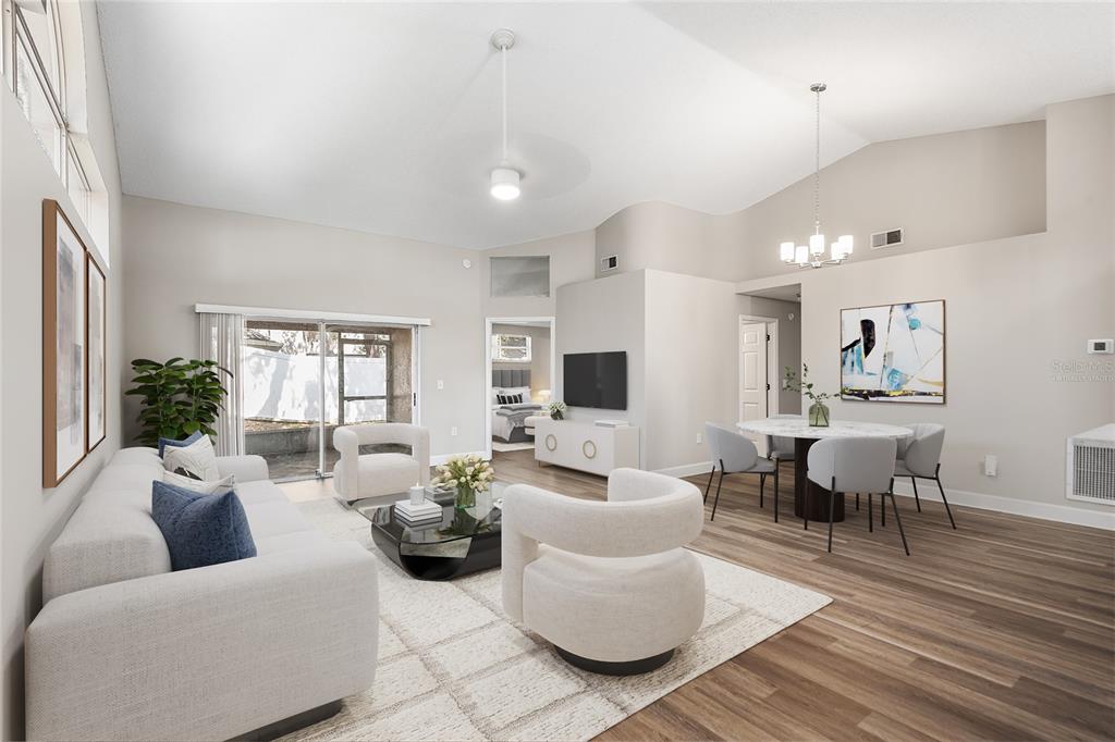 A living and dining area features vaulted ceilings, light wood flooring, and modern neutral furniture — 4011 LEVONSHIRE PLACE, VALRICO, FL