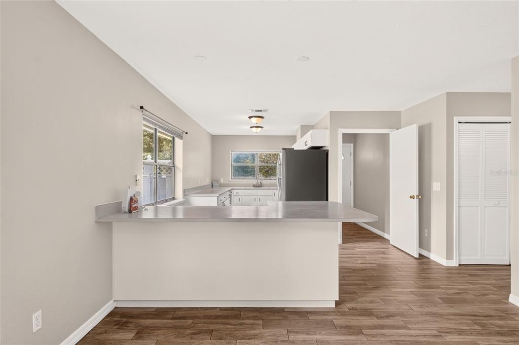 An open front door reveals a view of a grassy yard from a tiled entryway — 16310 NW 40TH PLACE, NEWBERRY, FL
