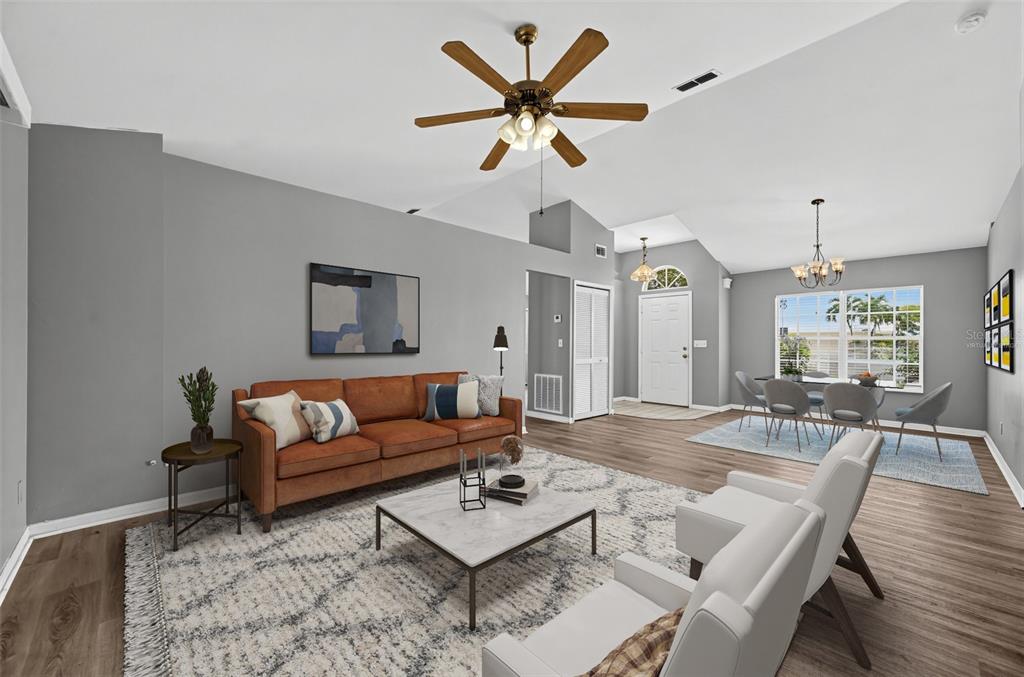 A living room with a brown sofa, white chairs, and a marble coffee table — 1325 SW 25TH TERRACE, CAPE CORAL, FL
