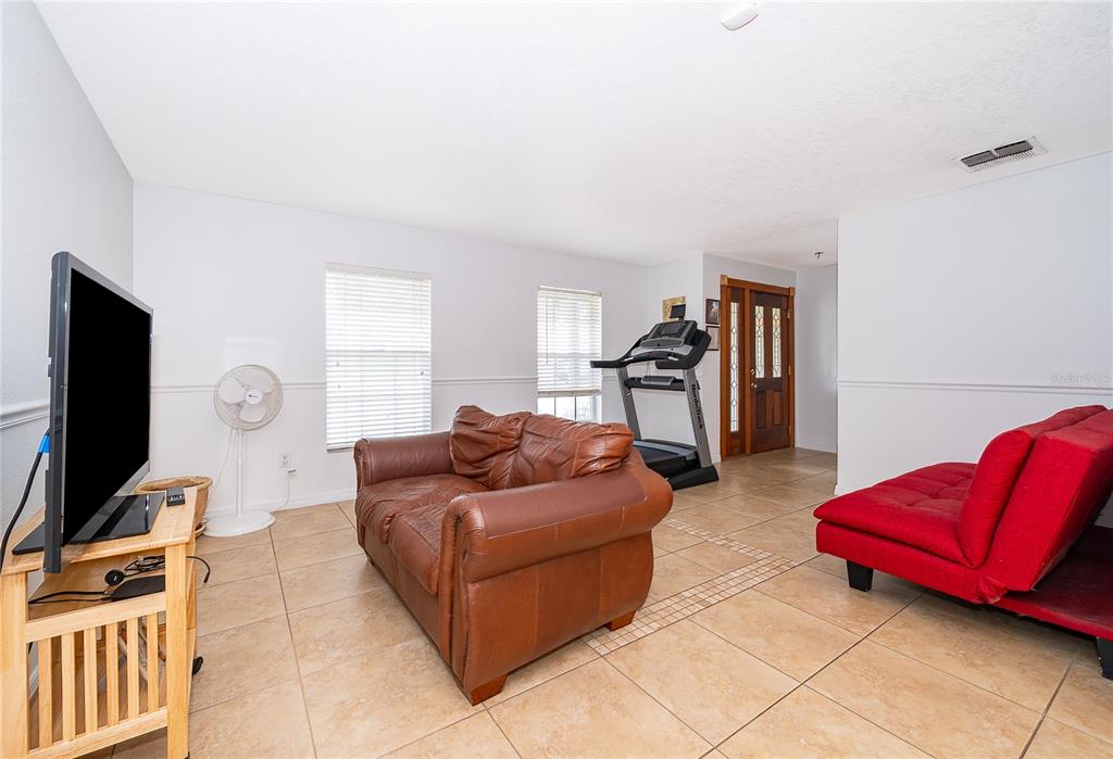 A kitchen with wood cabinets, granite countertops, tile backsplash, and tile flooring — 103 KILKENNY COURT, LONGWOOD, FL