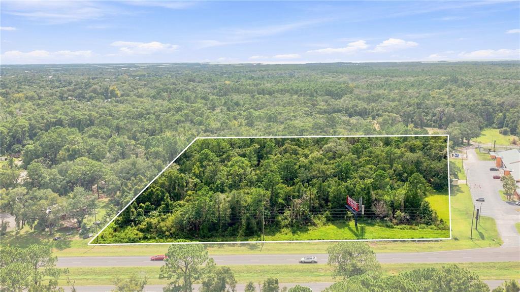An aerial view shows a rectangular, wooded plot of land bordered by a highway — 4366 N SUNCOAST BOULEVARD, CRYSTAL RIVER, FL