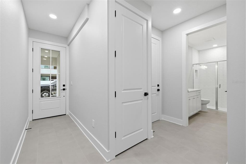 A bright entryway features white doors, light gray tile flooring, and a view into a bathroom — 4208 W CARMEN STREET UNIT B, TAMPA, FL