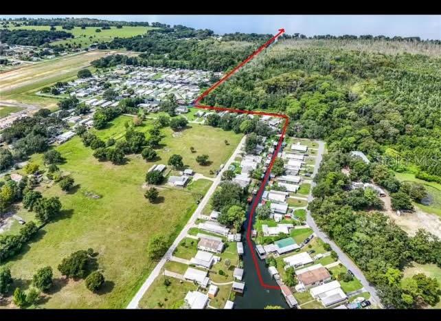 This aerial map shows a residential neighborhood with a canal and a red boundary line — 13508 PALM DRIVE, ASTATULA, FL