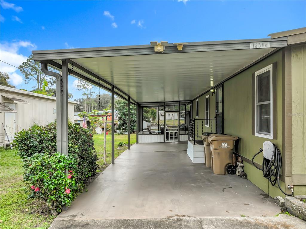 An aerial view shows a mobile home park with a red pin marking a specific lot — 13508 PALM DRIVE, ASTATULA, FL
