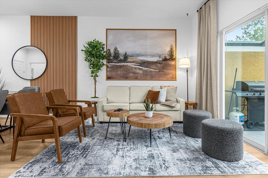 A living room features a beige sofa, two brown armchairs, and a large landscape painting — 3054 YELLOW LANTANA LANE, KISSIMMEE, FL