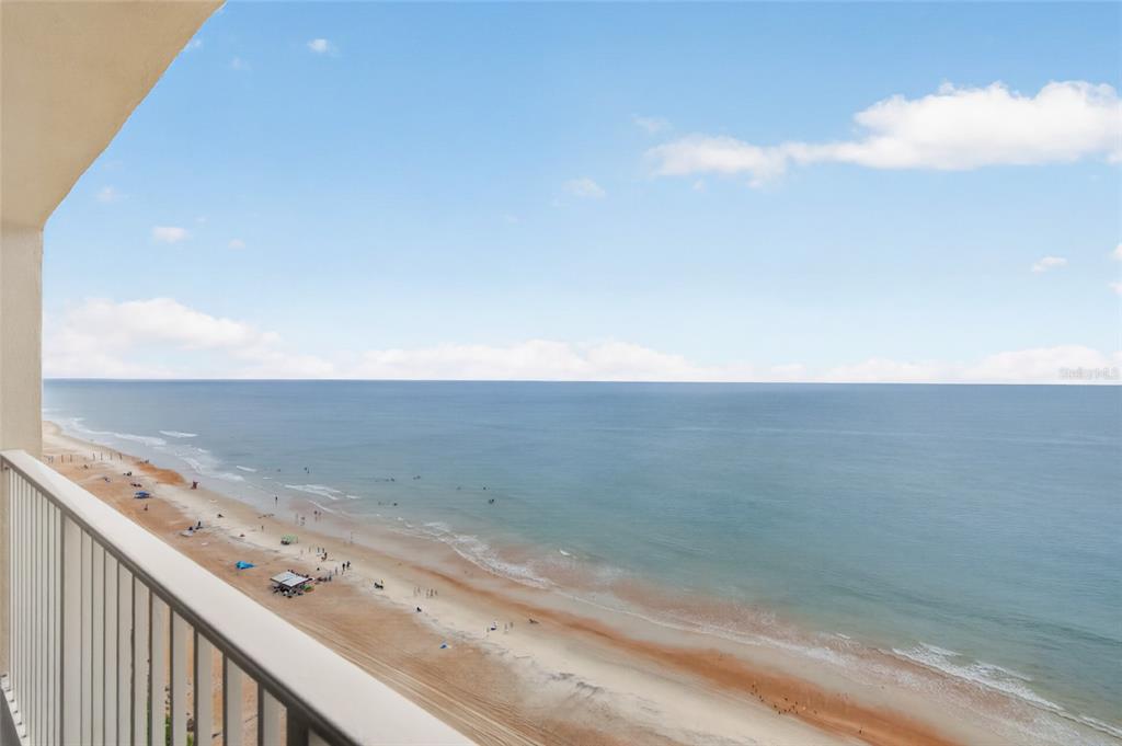 A high-angle view of a sandy beach and the ocean from a balcony — 89 S ATLANTIC AVENUE UNIT 1503, ORMOND BEACH, FL
