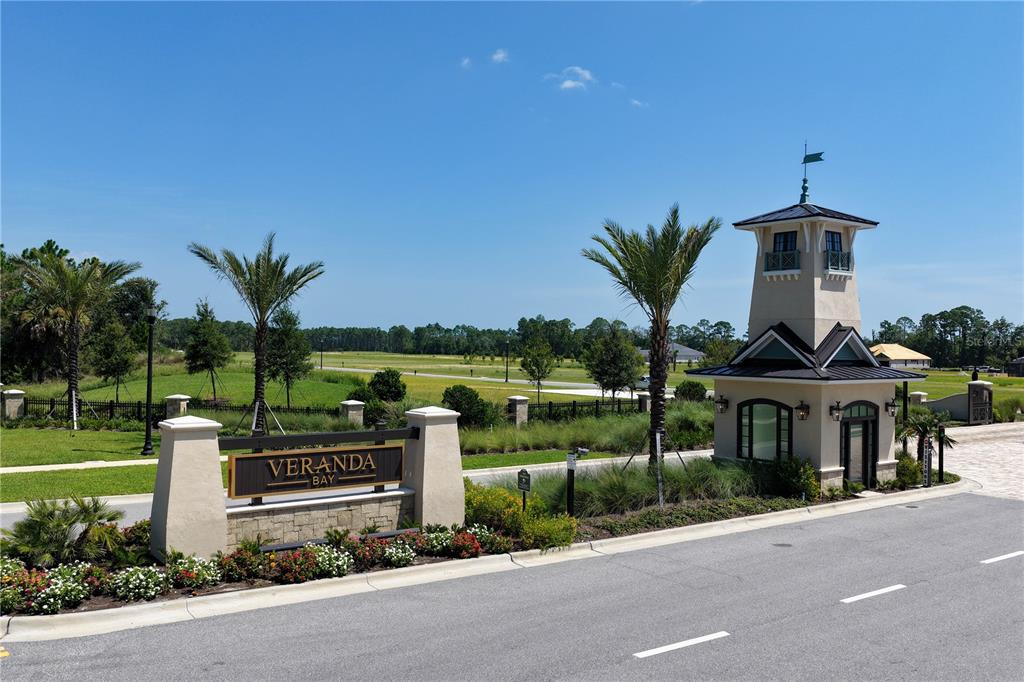 The entrance to Veranda Bay features a stone sign and a decorative tower structure — 89 CORONADO ROAD, FLAGLER BEACH, FL