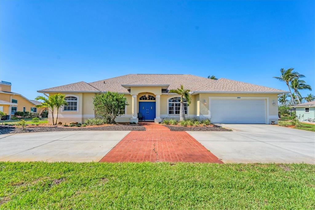 A single-story house with a yellow exterior, blue double doors, and a brick walkway — 285 SPANIARDS ROAD, PLACIDA, FL