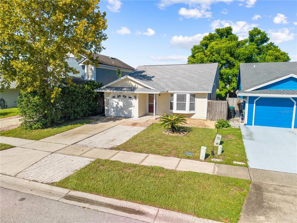 A single-story house with a light-colored exterior, a garage, and a front lawn — 1094 MARTIN BOULEVARD, ORLANDO, FL