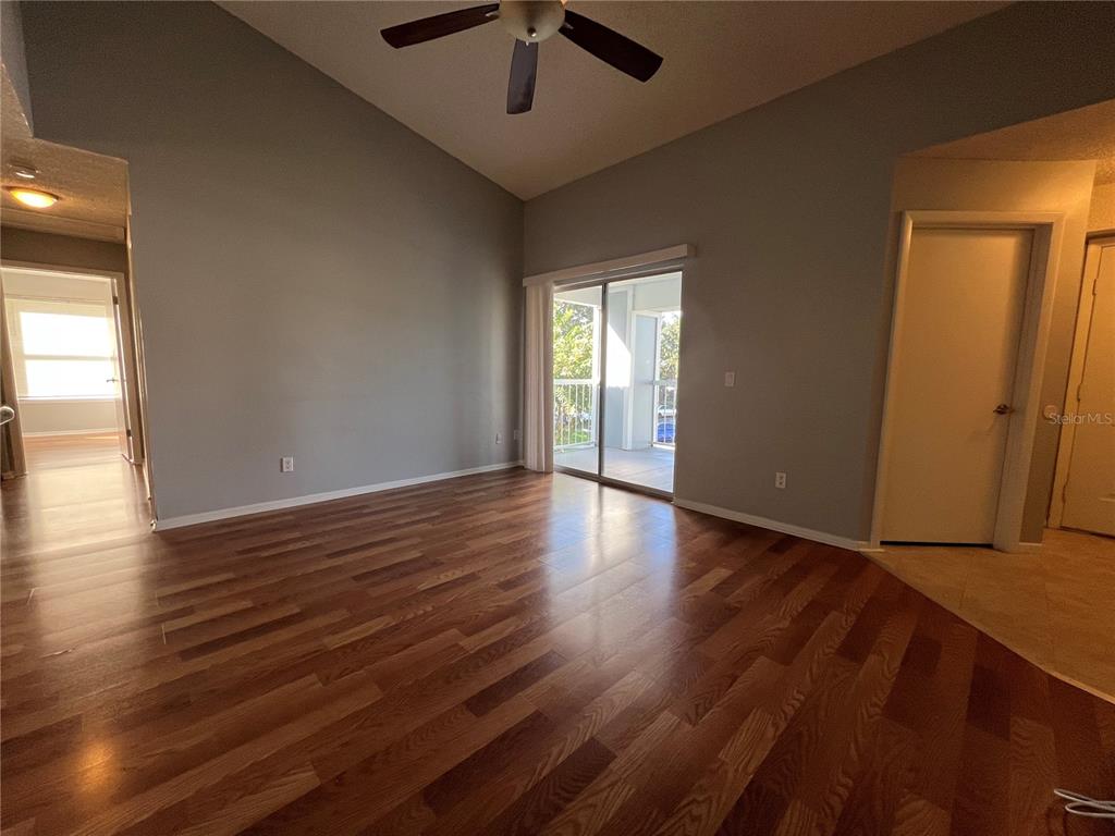 A two-story apartment building exterior features a central staircase leading to the upper level — 718 SUGAR BAY WAY UNIT 202, LAKE MARY, FL