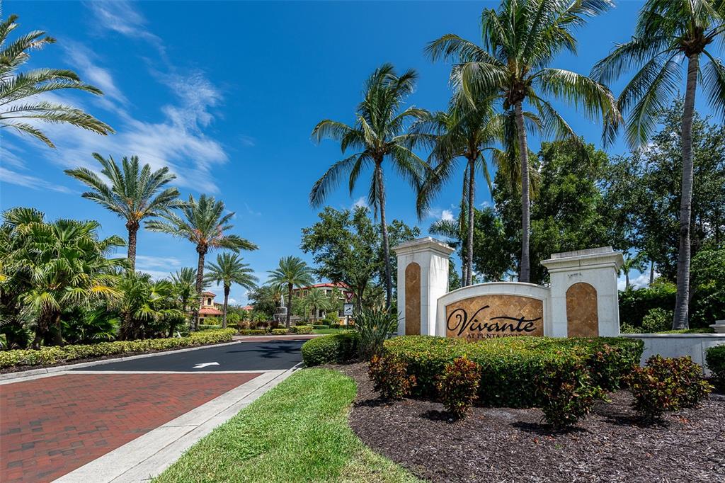 The entrance sign for Vivante at Punta Gorda features palm trees and a paved driveway — 85 VIVANTE BOULEVARD UNIT 8542, PUNTA GORDA, FL