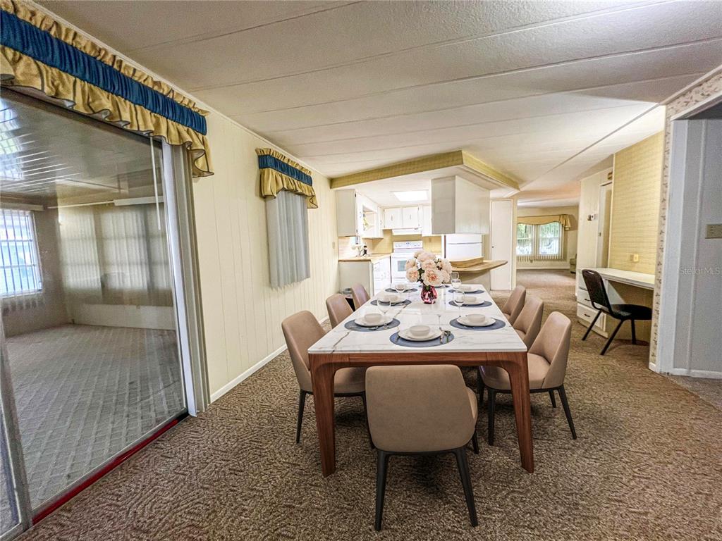 A dining room features a marble-topped table, beige chairs, and carpeted flooring — 326 MARTIN DRIVE, LAKELAND, FL