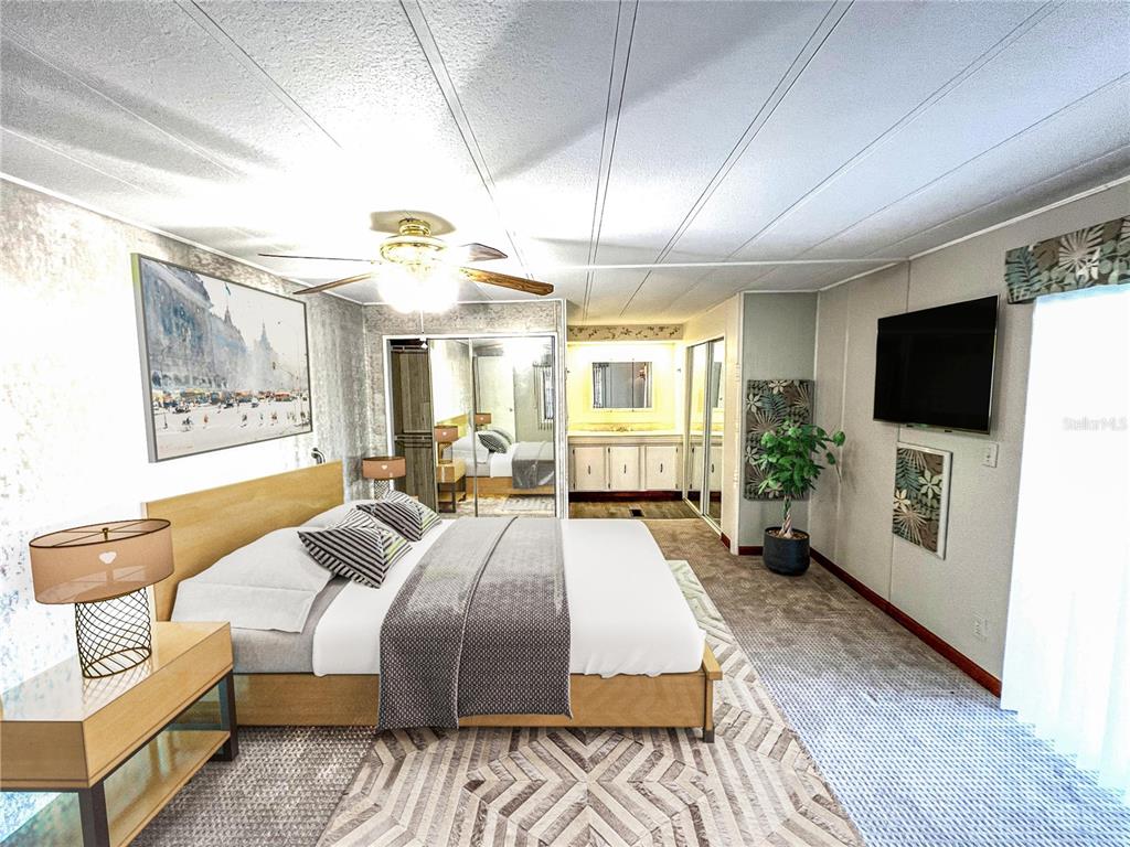 A bedroom features a bed, mirrored closet doors, a ceiling fan, and a wall-mounted television — 326 MARTIN DRIVE, LAKELAND, FL