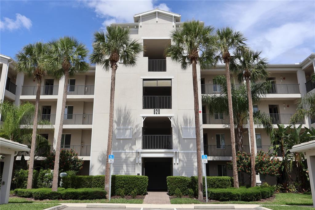 A multi-story apartment building with a covered parking structure in the foreground — 920 TIDEWATER SHORES LOOP UNIT 301, BRADENTON, FL
