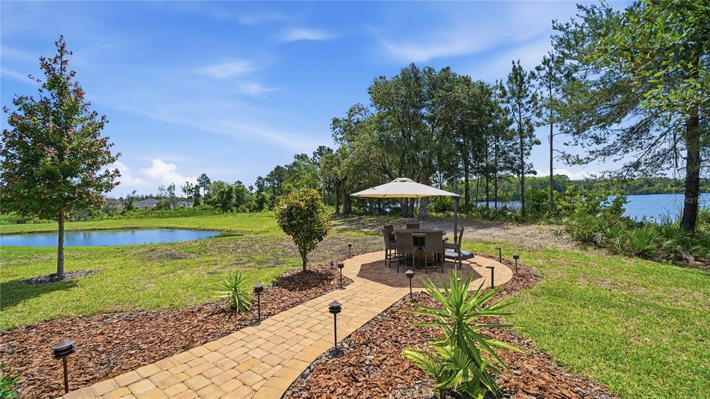 An aerial view of a two-story suburban house with a paved driveway and lake view — 367 LAKE SINCLAIR STREET, ST AUGUSTINE, FL