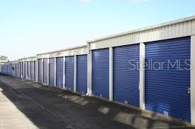 A long row of blue metal roll-up doors on a self-storage facility building — 16881 SW ARCHER ROAD, ARCHER, FL