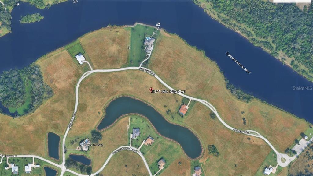 This is an aerial map view of a residential property located along a river — 2071 SILK BAY BOULEVARD, ALVA, FL