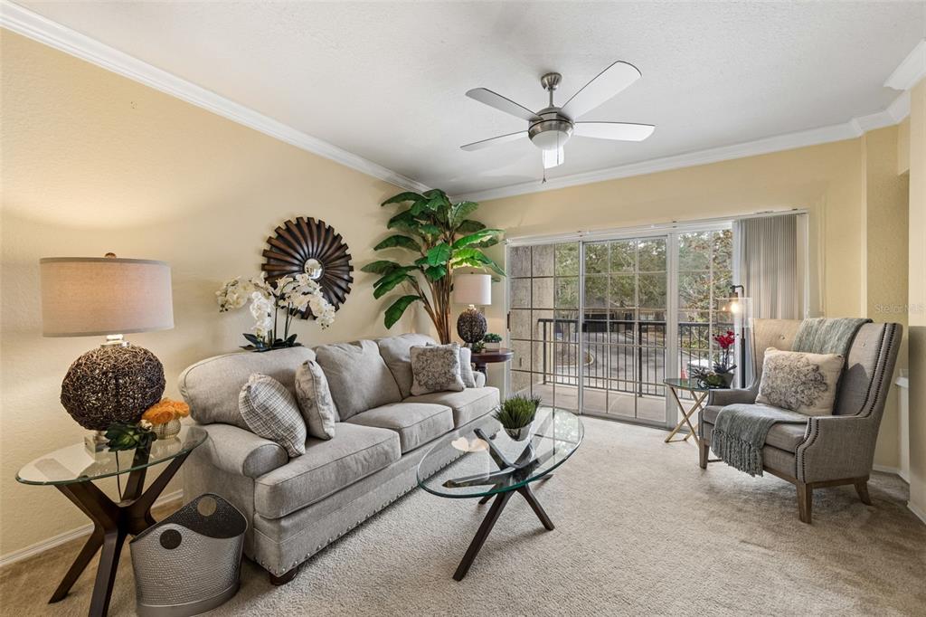 A two-story tan stucco building exterior features a balcony, a garage, and a building number — 143 VILLA DI ESTE TERRACE UNIT 209, LAKE MARY, FL