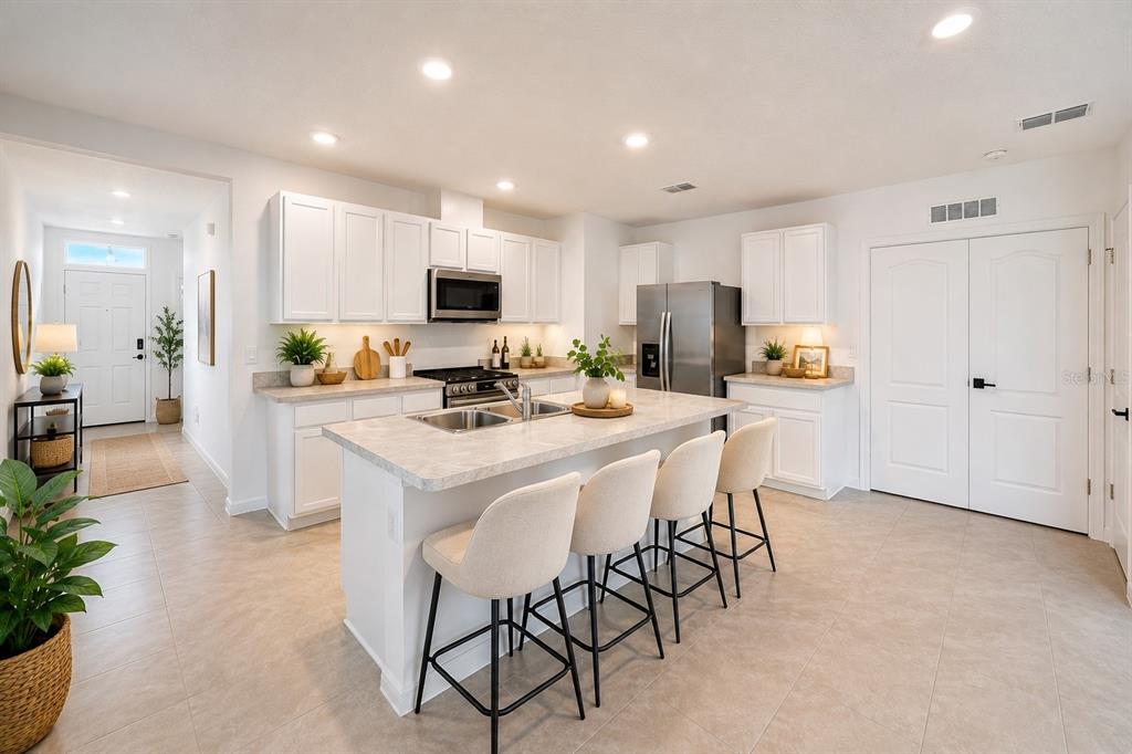 A single-story house with a gray exterior, a two-car garage, and a concrete driveway — 2733 REDDISH EGRET BEND, HARMONY, FL