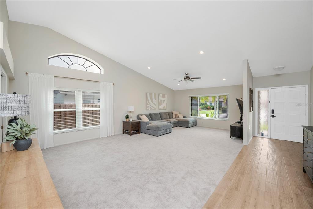 A view from an open front door into a home with wood-look tile flooring — 12004 STEPPINGSTONE BOULEVARD, TAMPA, FL
