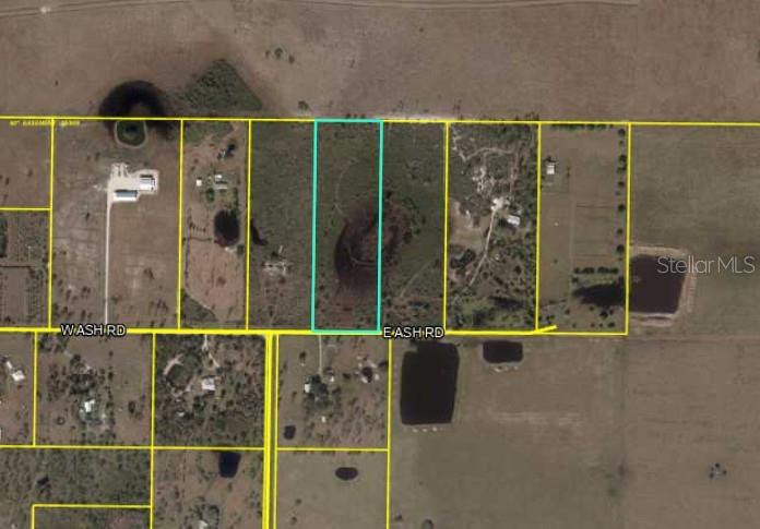 This is an aerial map showing a rectangular parcel of land outlined in light blue — 1065 E ASH ROAD, LABELLE, FL