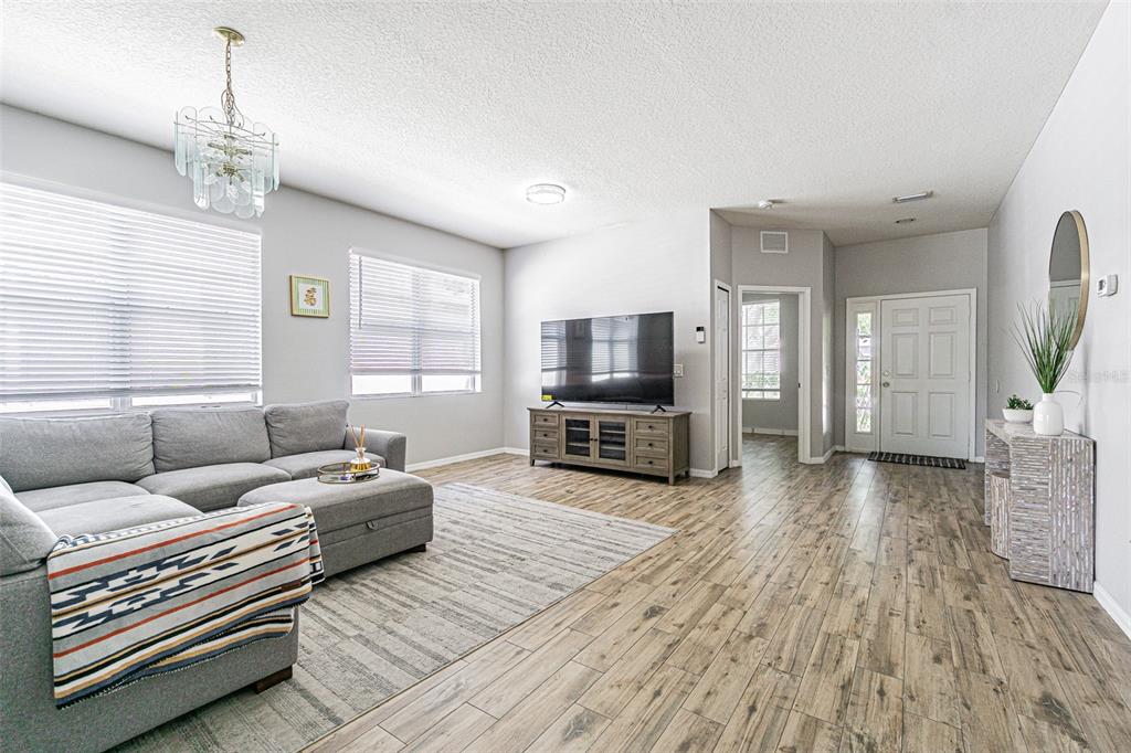 A kitchen with white cabinets, stainless steel appliances, granite countertops, and wood-look flooring — 13016 TERRACE BROOK PLACE, TEMPLE TERRACE, FL