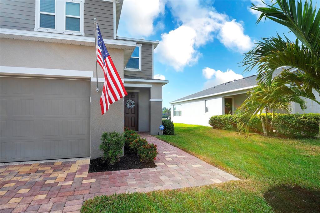 A two-story house with a paved driveway, a front door, and an American flag — 11507 GALLATIN TRAIL, PARRISH, FL