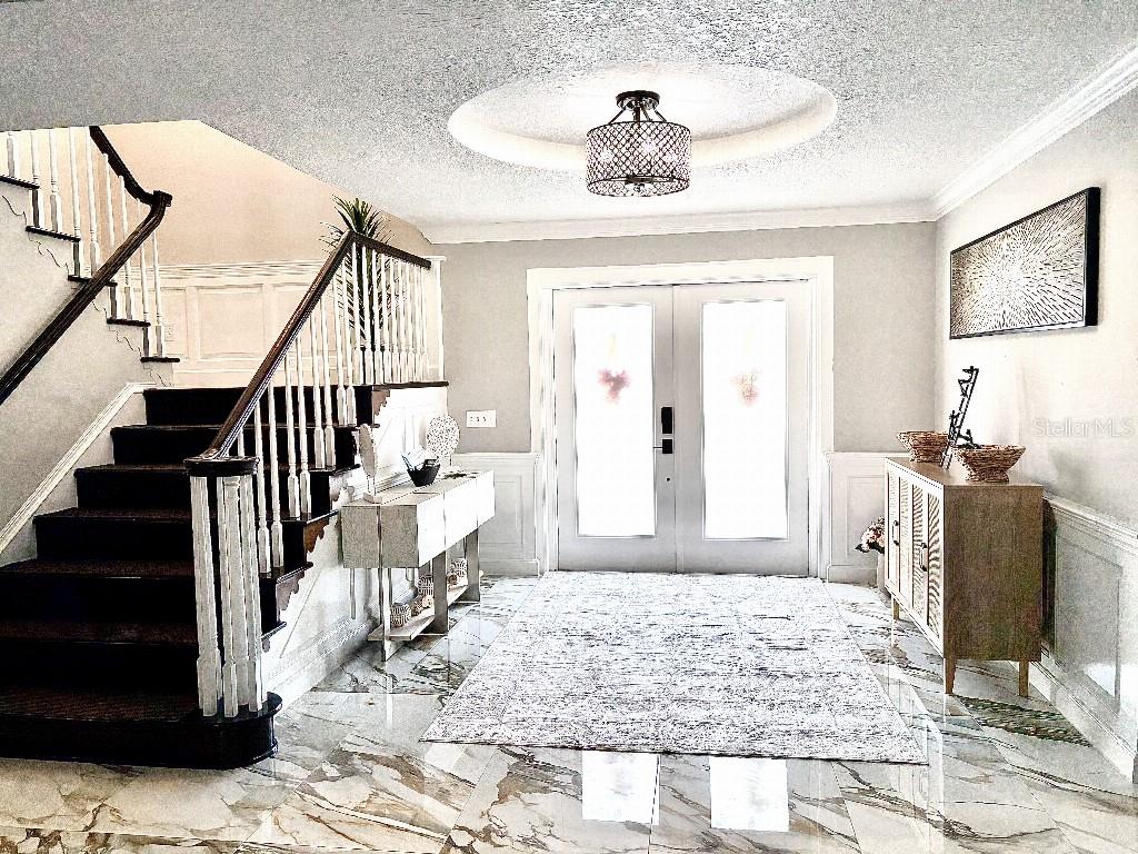 A foyer features a marble floor, a staircase with dark treads, and a circular ceiling light — 154 LOOKOUT POINT DRIVE, OSPREY, FL