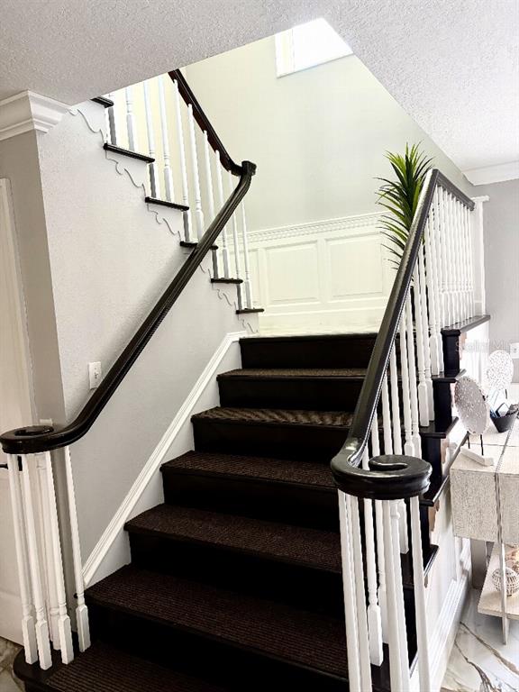 A staircase with dark wood treads and white railings leads to an upper landing — 154 LOOKOUT POINT DRIVE, OSPREY, FL
