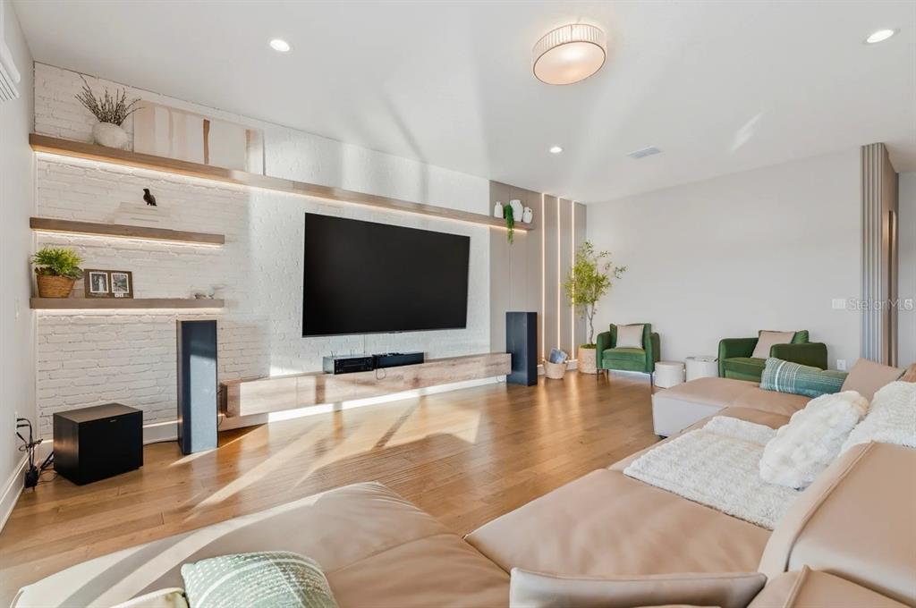 A two-story house with a three-car garage, light gray siding, and a brick paver driveway — 3387 BUOY CIRCLE, WINTER GARDEN, FL