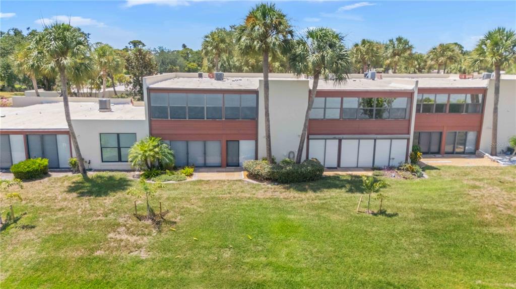 An exterior view of a two-story multi-unit building with flat roofs and palm trees — 514 SPRING LAKES BOULEVARD, BRADENTON, FL