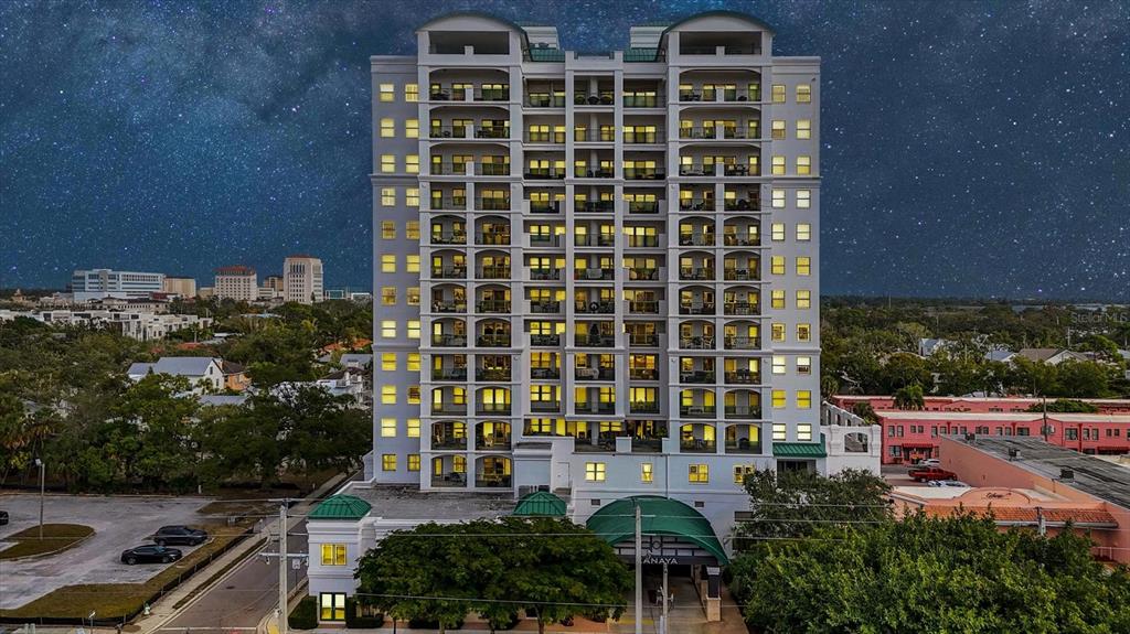 An exterior view of a multi-story residential building with balconies under a starry night sky — 505 S ORANGE AVENUE UNIT 301, SARASOTA, FL