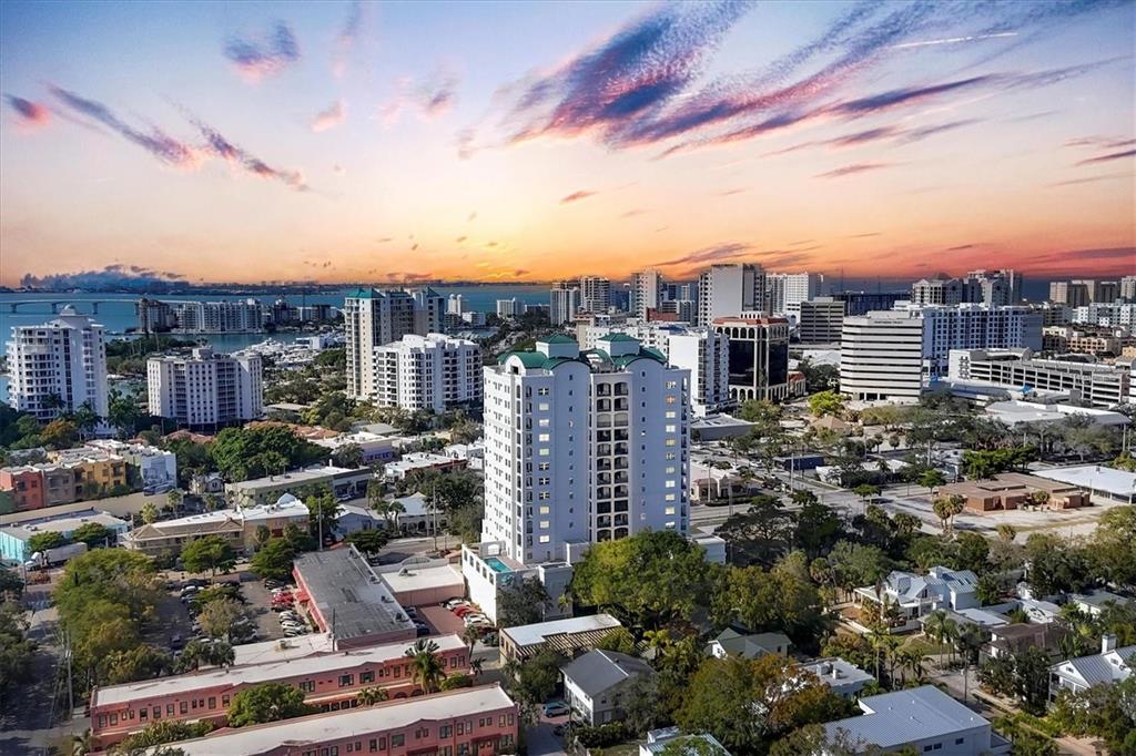 An aerial view of a city skyline with high-rise buildings at sunset near the water — 505 S ORANGE AVENUE UNIT 301, SARASOTA, FL