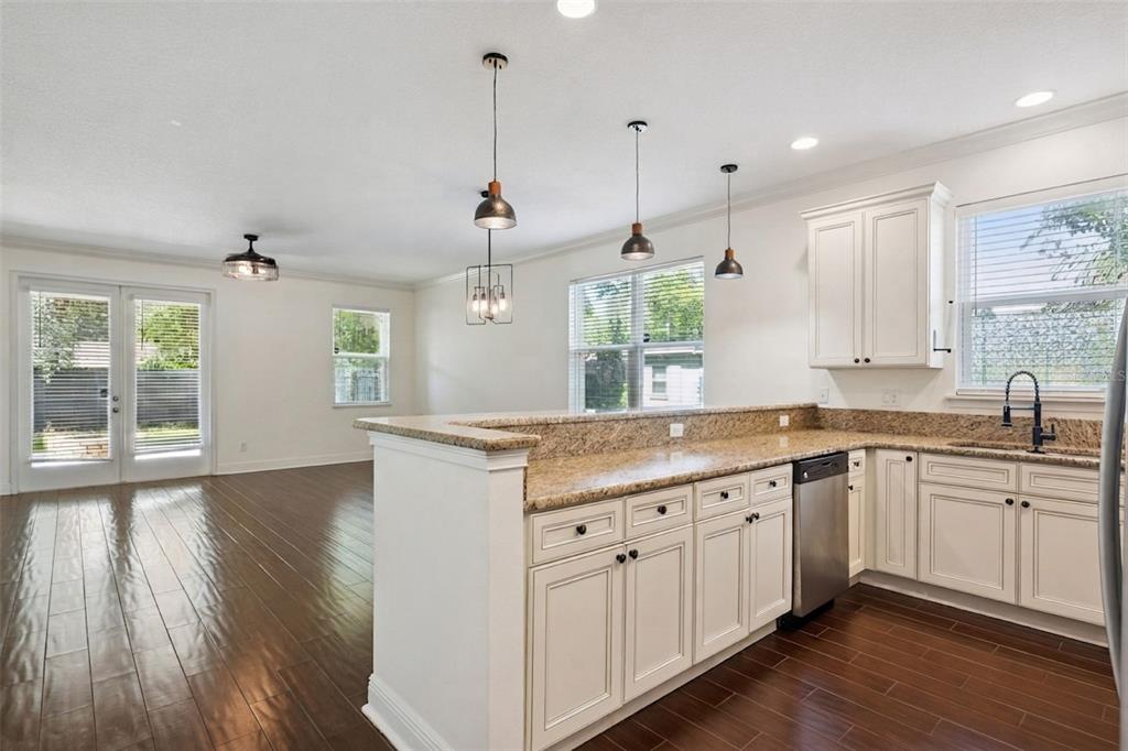 The exterior of a two-story house features green siding, a white door, and a garage — 2806 KILGORE STREET, ORLANDO, FL