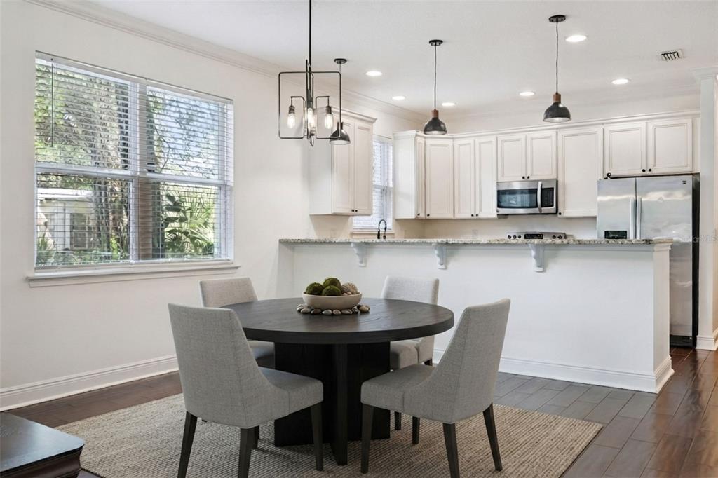 A living room features a gray sofa, a blue armchair, a coffee table, and hardwood floors — 2806 KILGORE STREET, ORLANDO, FL